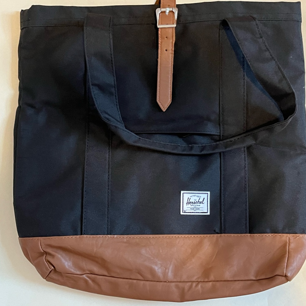 Hershel supply company black tote bag with leather bottom.
